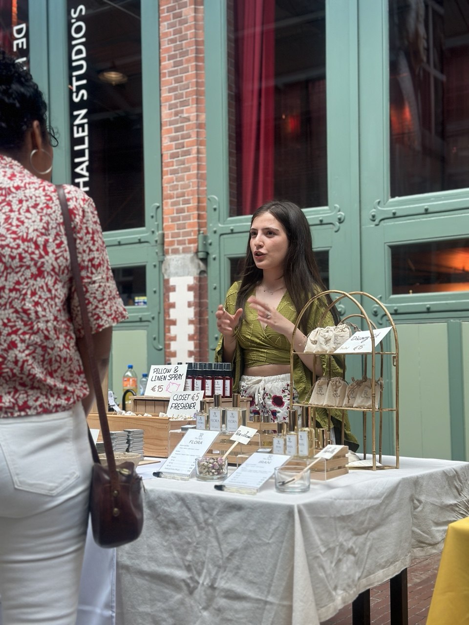 Tara Rafati talking with a customer about her handmade perfumes